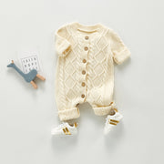 Stickad babyjumpsuit med knappar