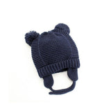 Stickad babymössa med öron och tofsar 